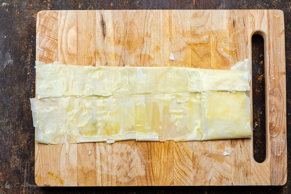 feta being wrapped in phyllo dough