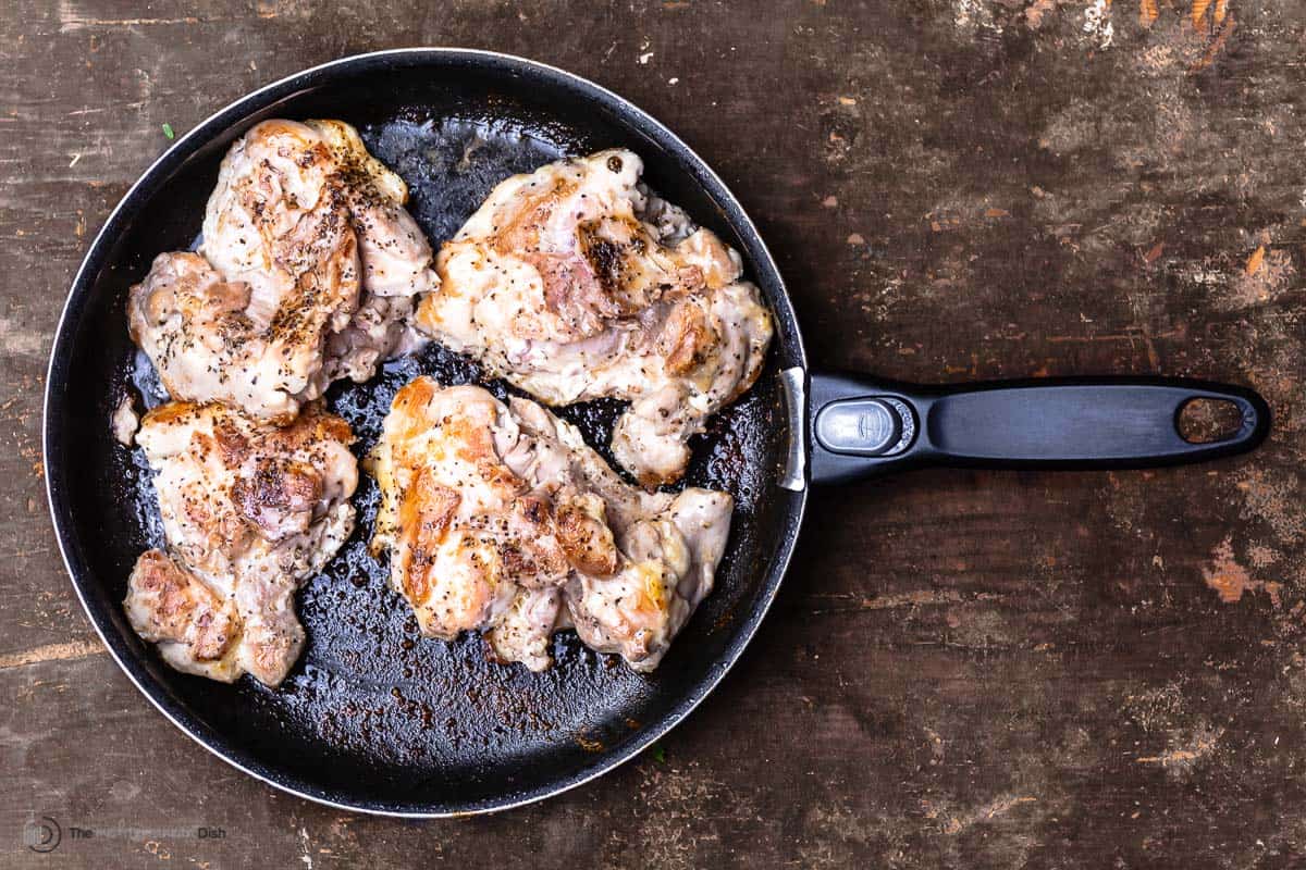 chicken thighs cooked in a skillet