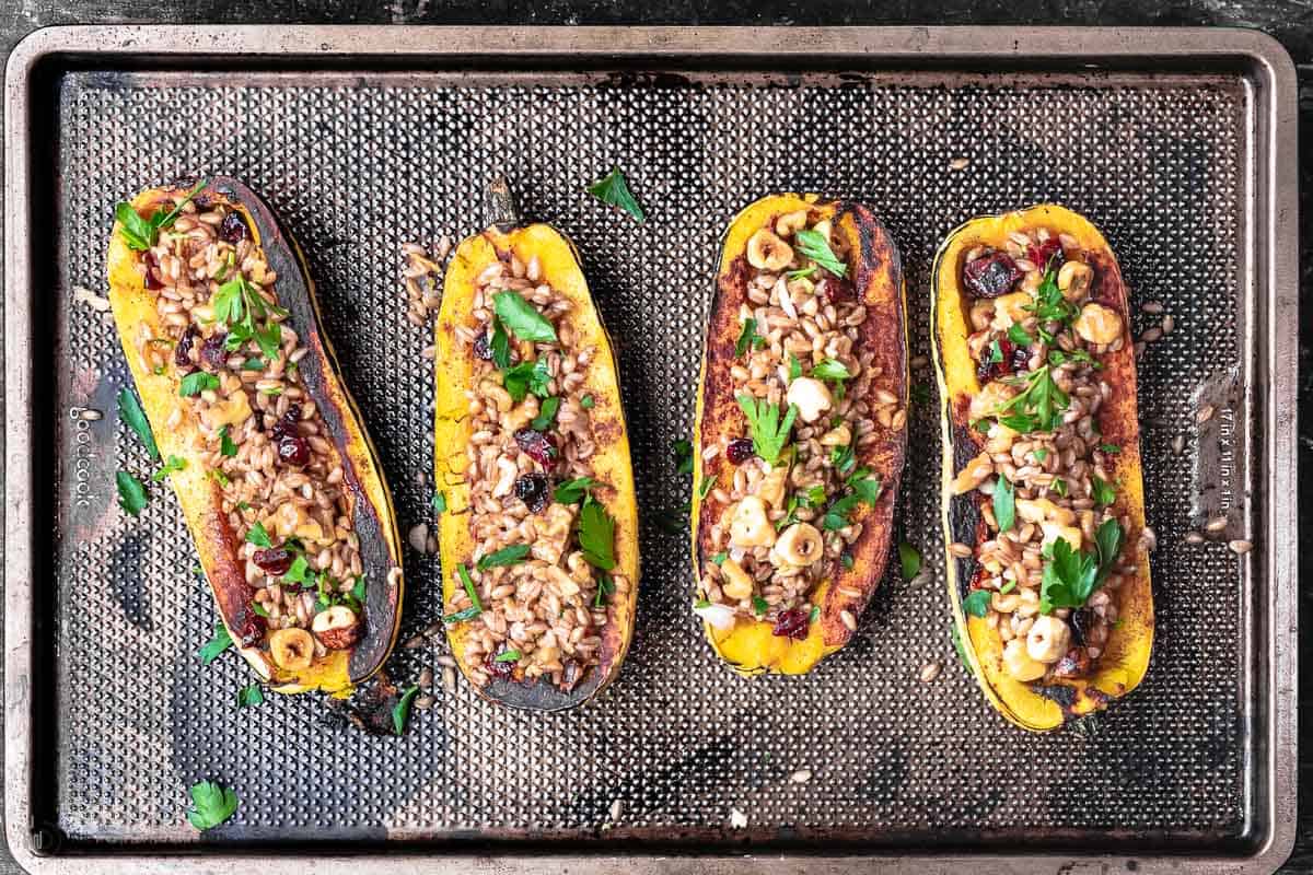 stuffed winter squash on a baking sheet