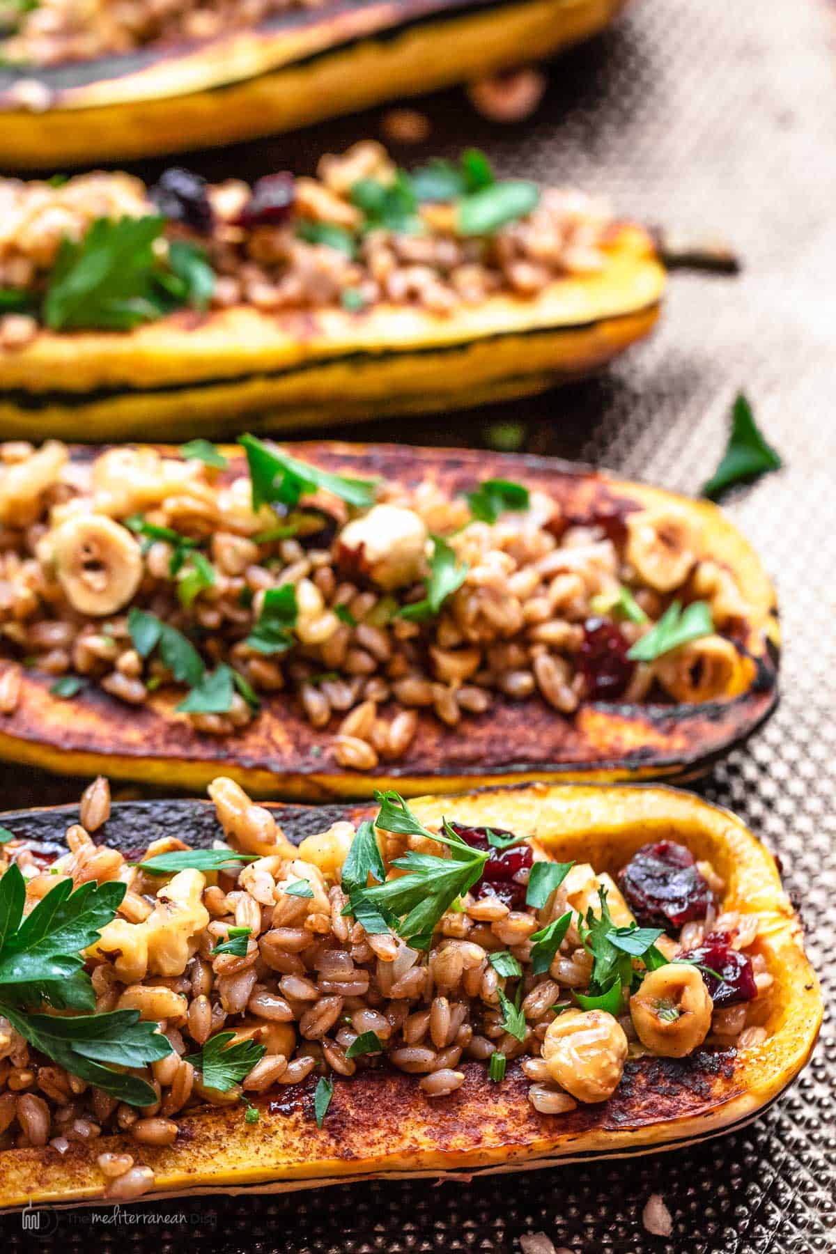 roasted delicata squash halves filled with spiced farro mixture
