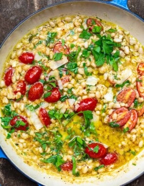 garlic parmesan white beans with cherry tomatoes in a pot