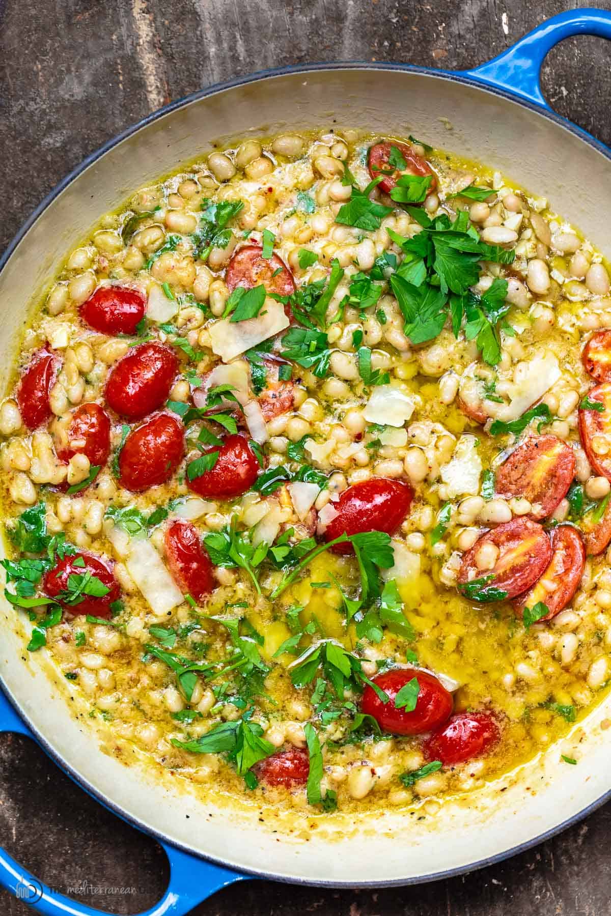 garlic parmesan white beans with cherry tomatoes in a pot