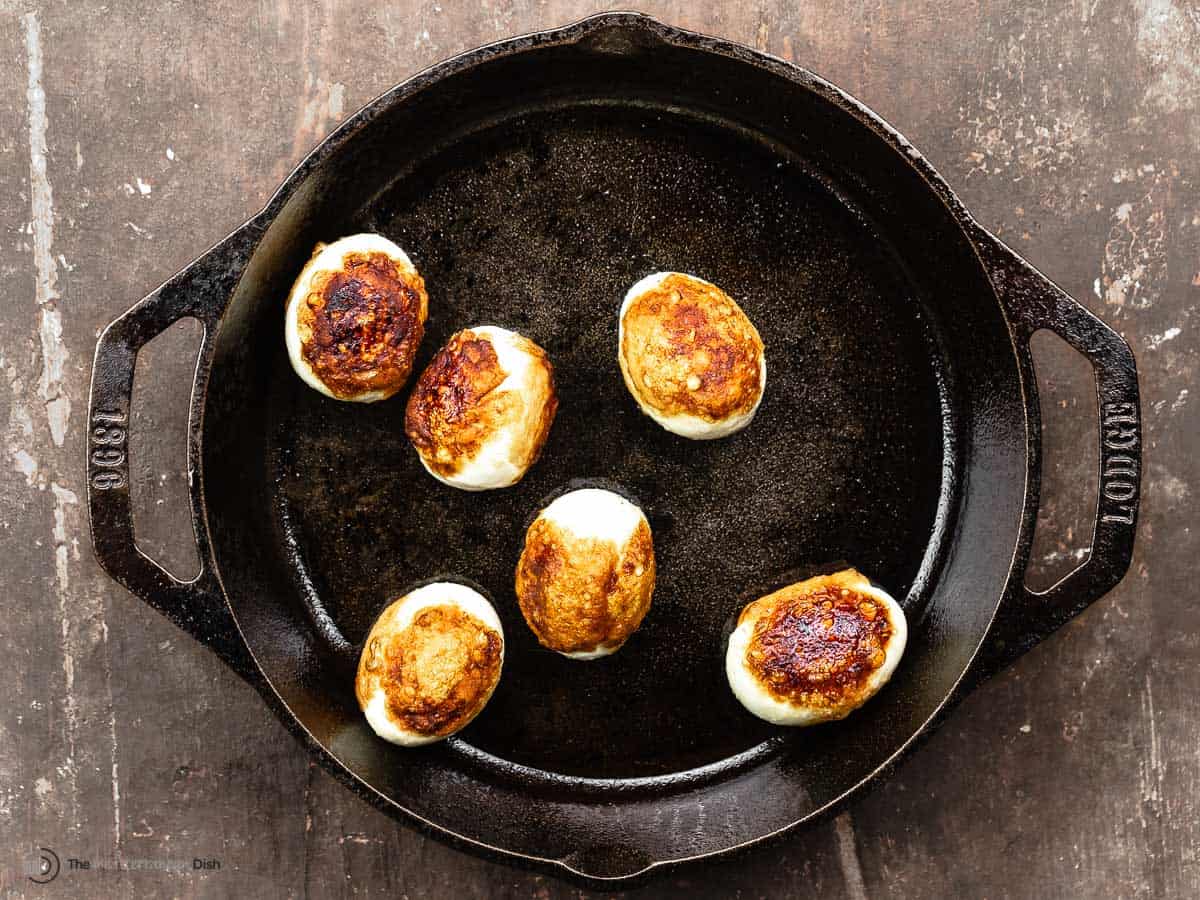 fried hard boiled eggs in a small cast iron skillet