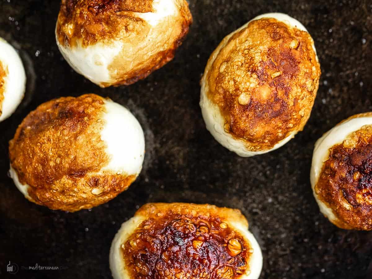 Hard boiled fried eggs in a cast iron pan