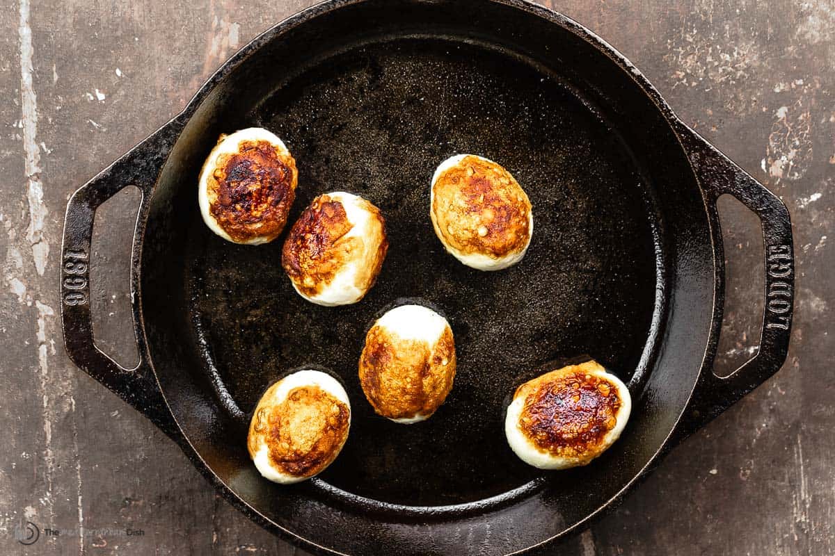 fried hard boiled eggs in a small cast iron skillet