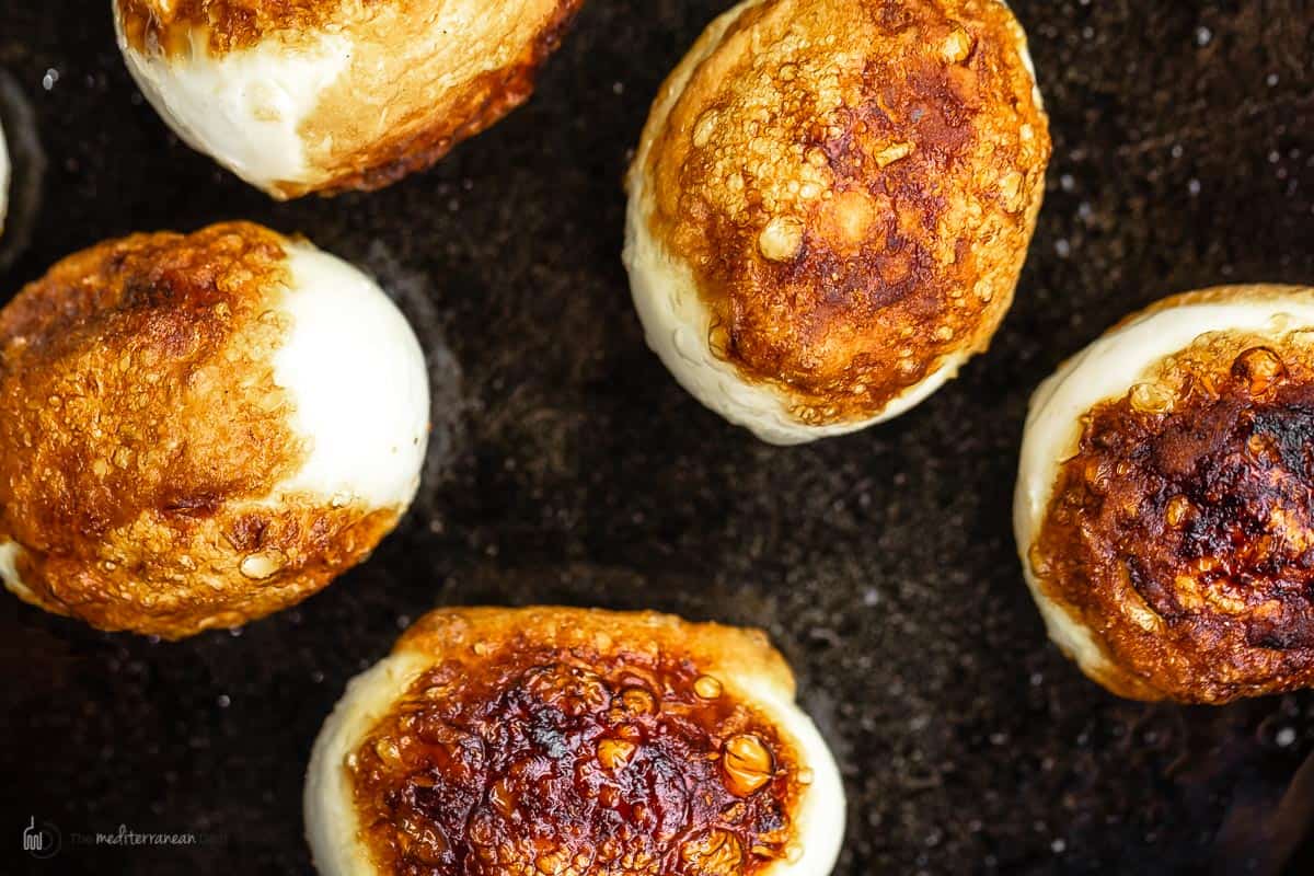 Hard boiled fried eggs in a cast iron pan