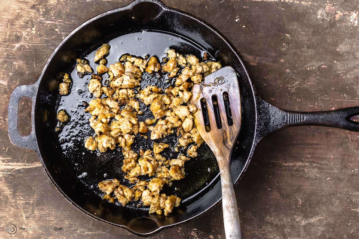 sausage cooking in a skillet