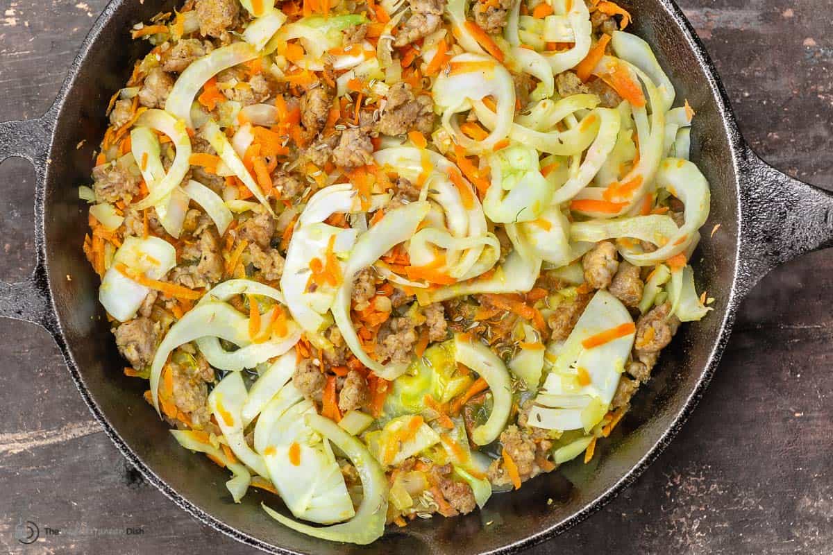 sausage, lentils, fennel, and grated carrot in a skillet