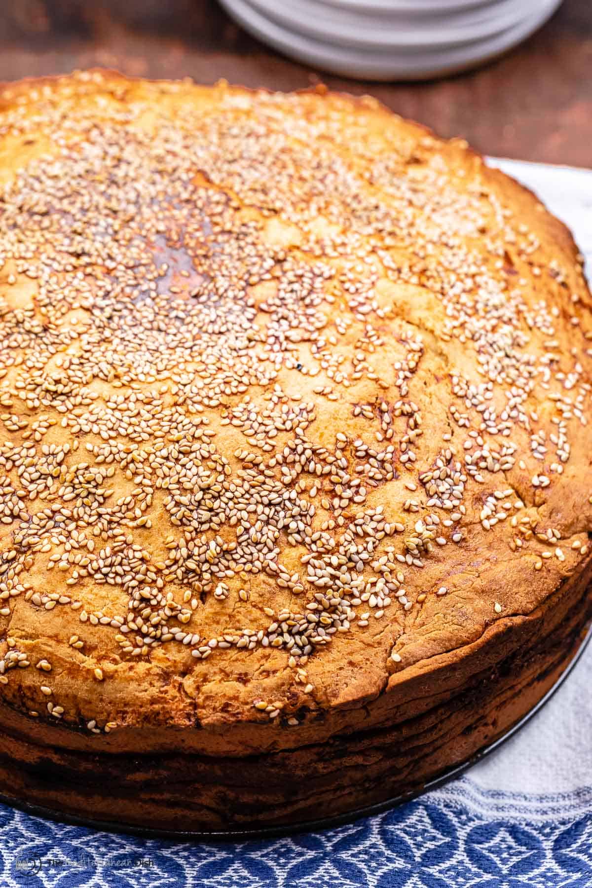 vasilopita topped with sesame seeds