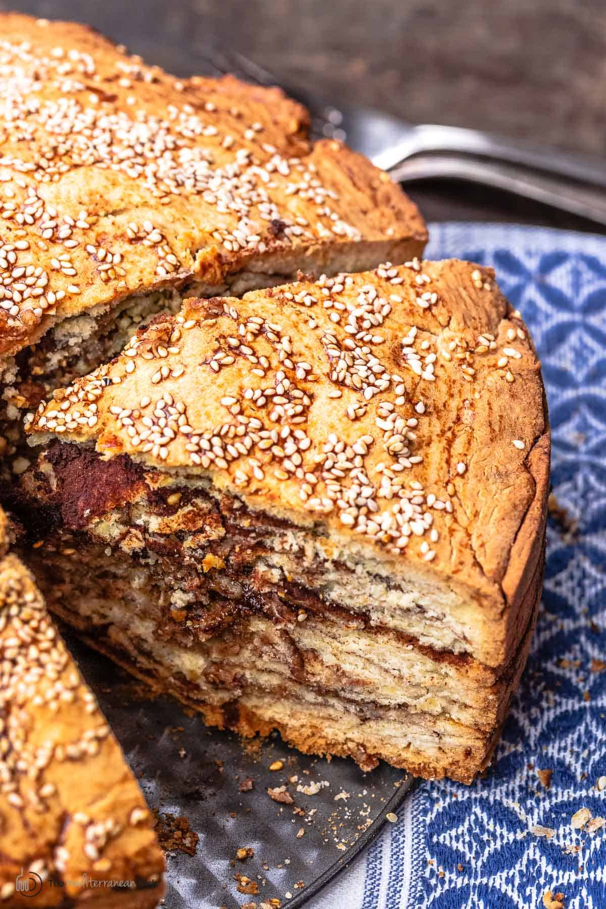 slice of vasilopita showing layers and cinnamon sugar mixture