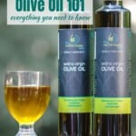 two bottles of olive oil next to a glass vessel containing olive oil