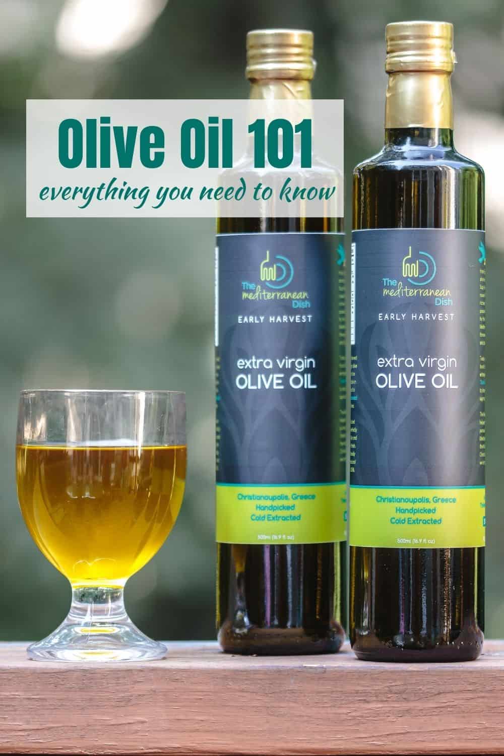 two bottles of olive oil next to a glass vessel containing olive oil