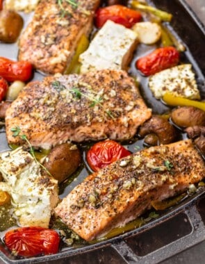 baked salmon fillet with mushrooms, feta, cherry tomatoes, garlic, and bell peppers