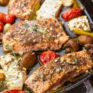 baked salmon fillet with mushrooms, feta, cherry tomatoes, garlic, and bell peppers
