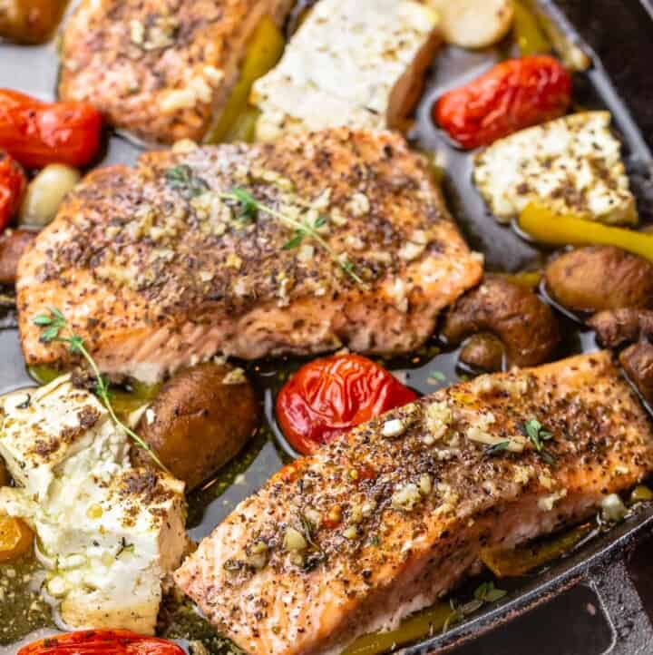 baked salmon fillet with mushrooms, feta, cherry tomatoes, garlic, and bell peppers