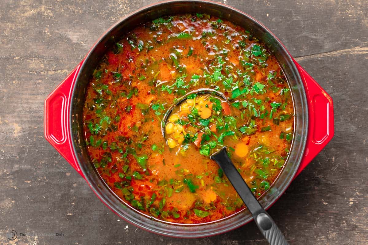 chickpea soup in a Dutch oven topped with fresh parsley