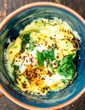 Close up of one mug with an omelet cooked with veggies in the microwave