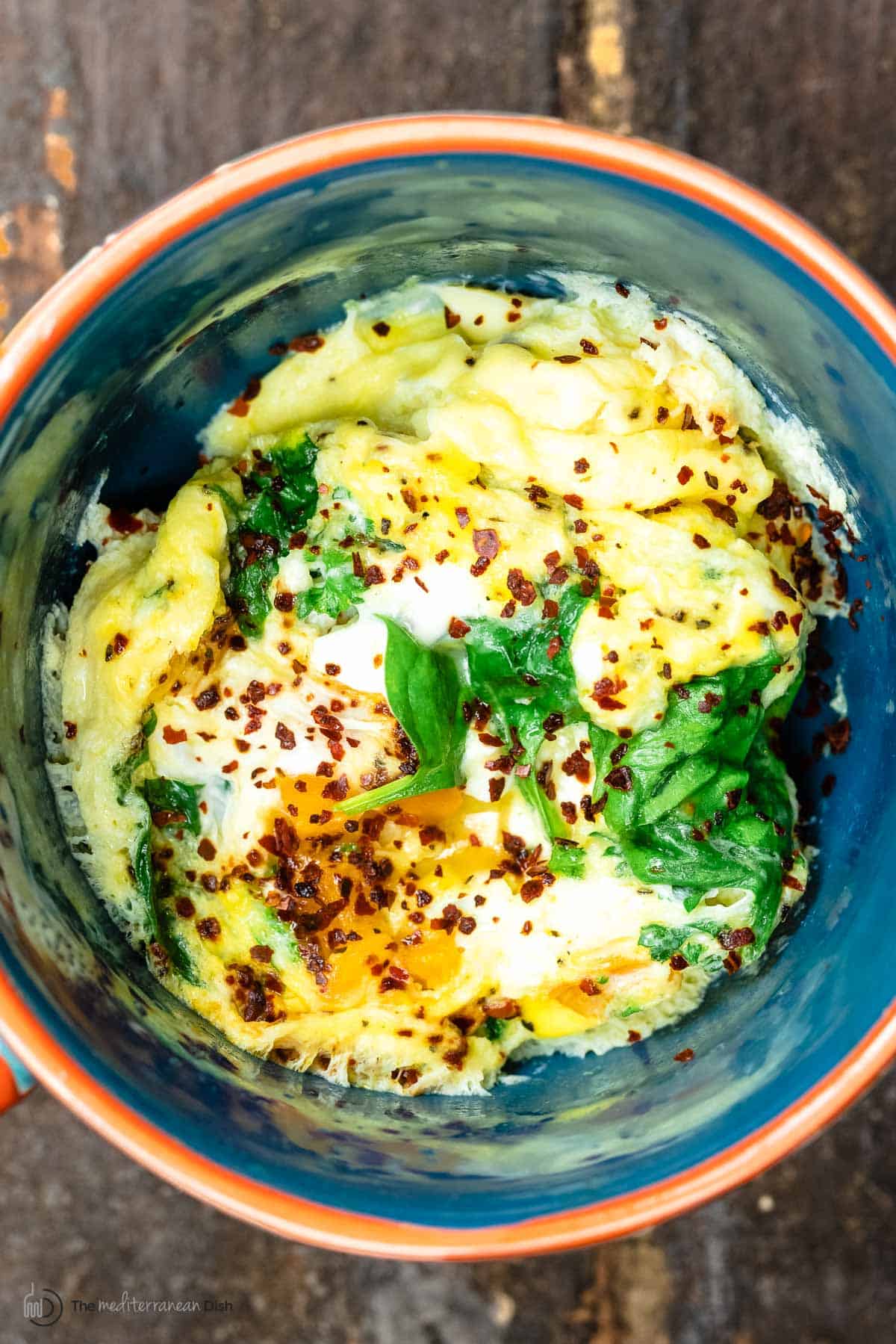 Close up of one mug with an omelet cooked with veggies in the microwave