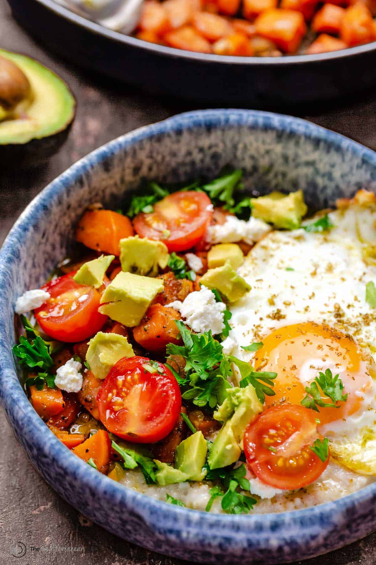 savory oatmeal bowl with egg, sweet potatoes, avocados and more