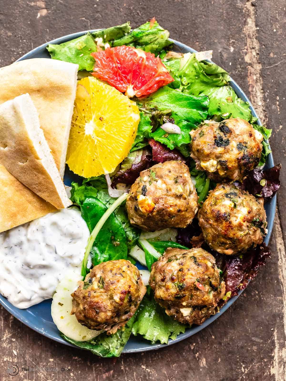 meatballs with citrus salad, pita, and yogurt dip