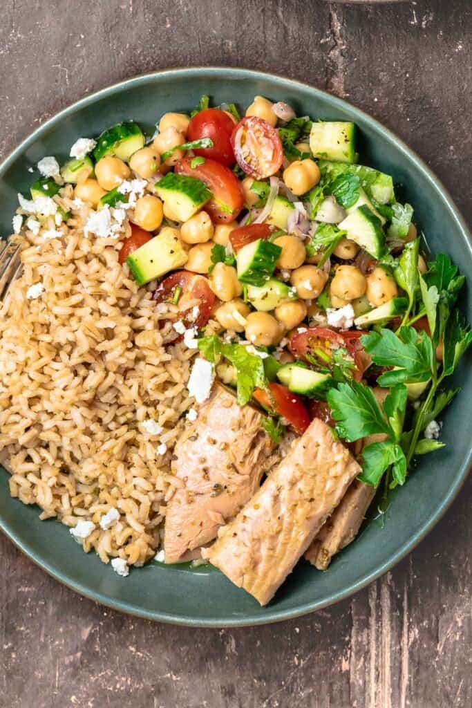 One rice bowl with tuna and Mediterranean salad with chickpeas, tomatoes, and cucumbers