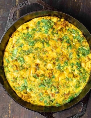 herby potato omelet in a skillet