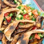 vegan shawarma with mushrooms in pita alongside a Mediterranean salad