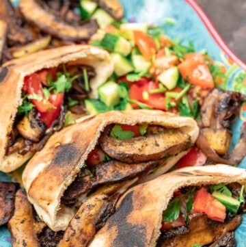 vegan shawarma with mushrooms in pita alongside a Mediterranean salad