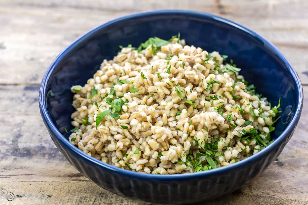 horizontal image of barley in a blue bowl