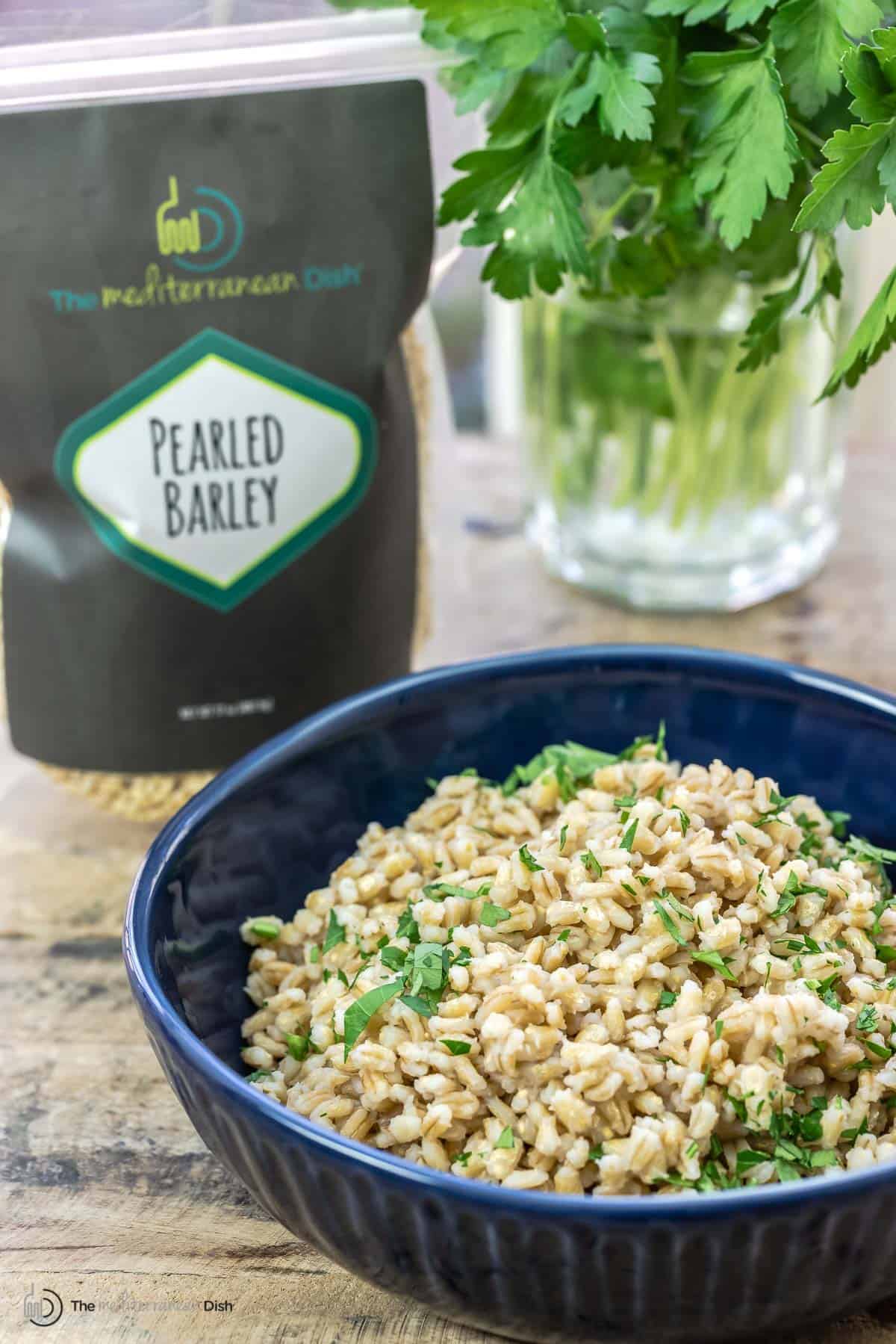 barley in a bowl with a bag of dry barley in the back