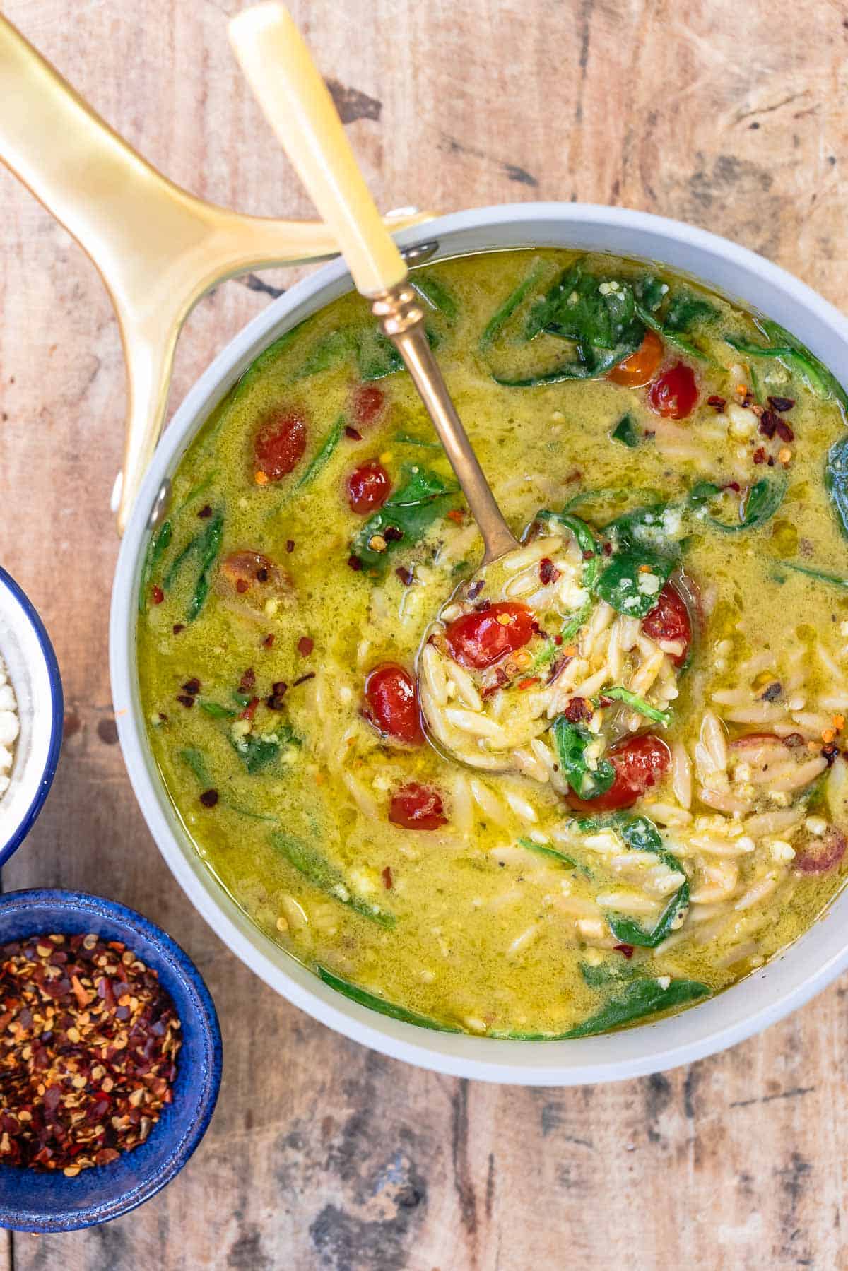 pasta soup with pesto and lemon in a large saucepan