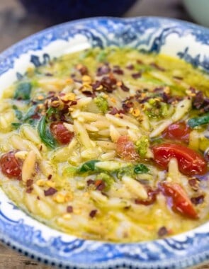 close-up of pesto lemon orzo soup in a bowl