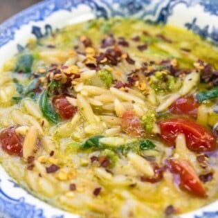 close-up of pesto lemon orzo soup in a bowl