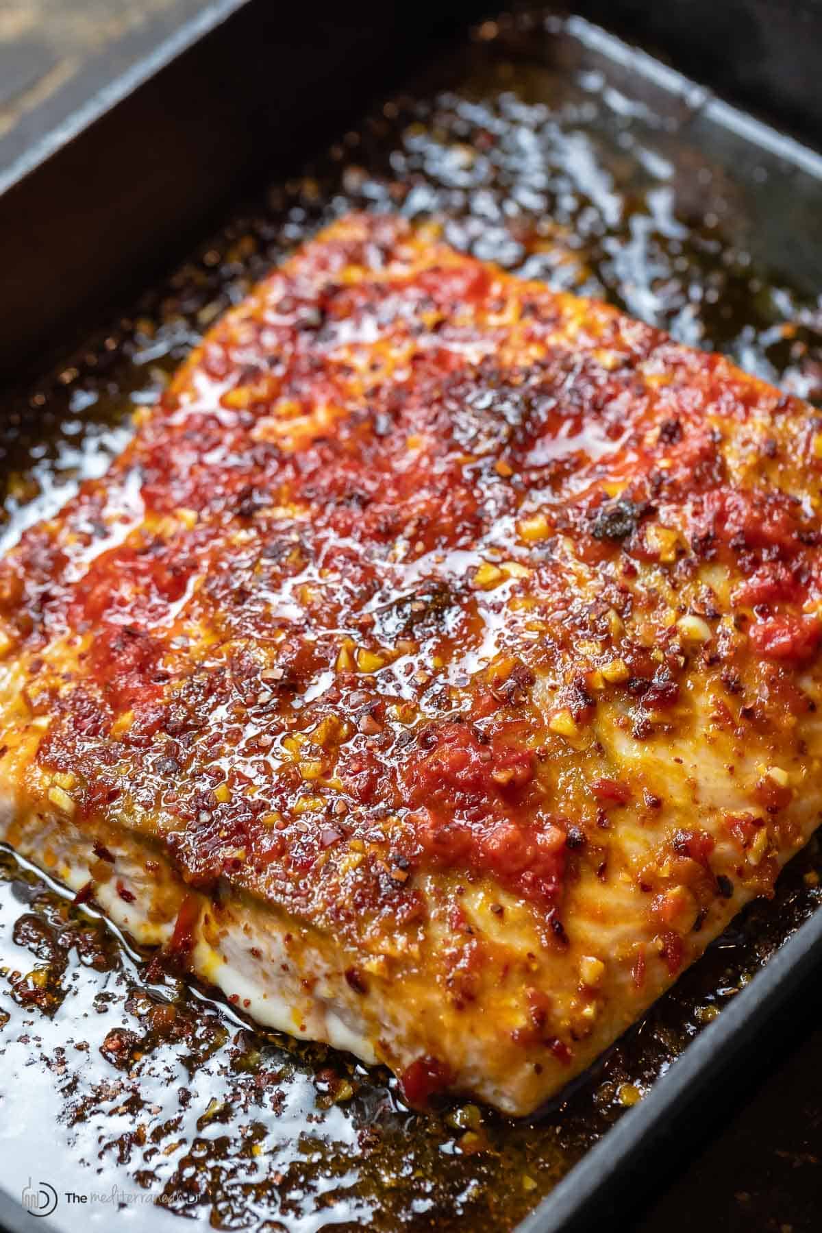 spicy salmon with harissa sauce in a baking dish