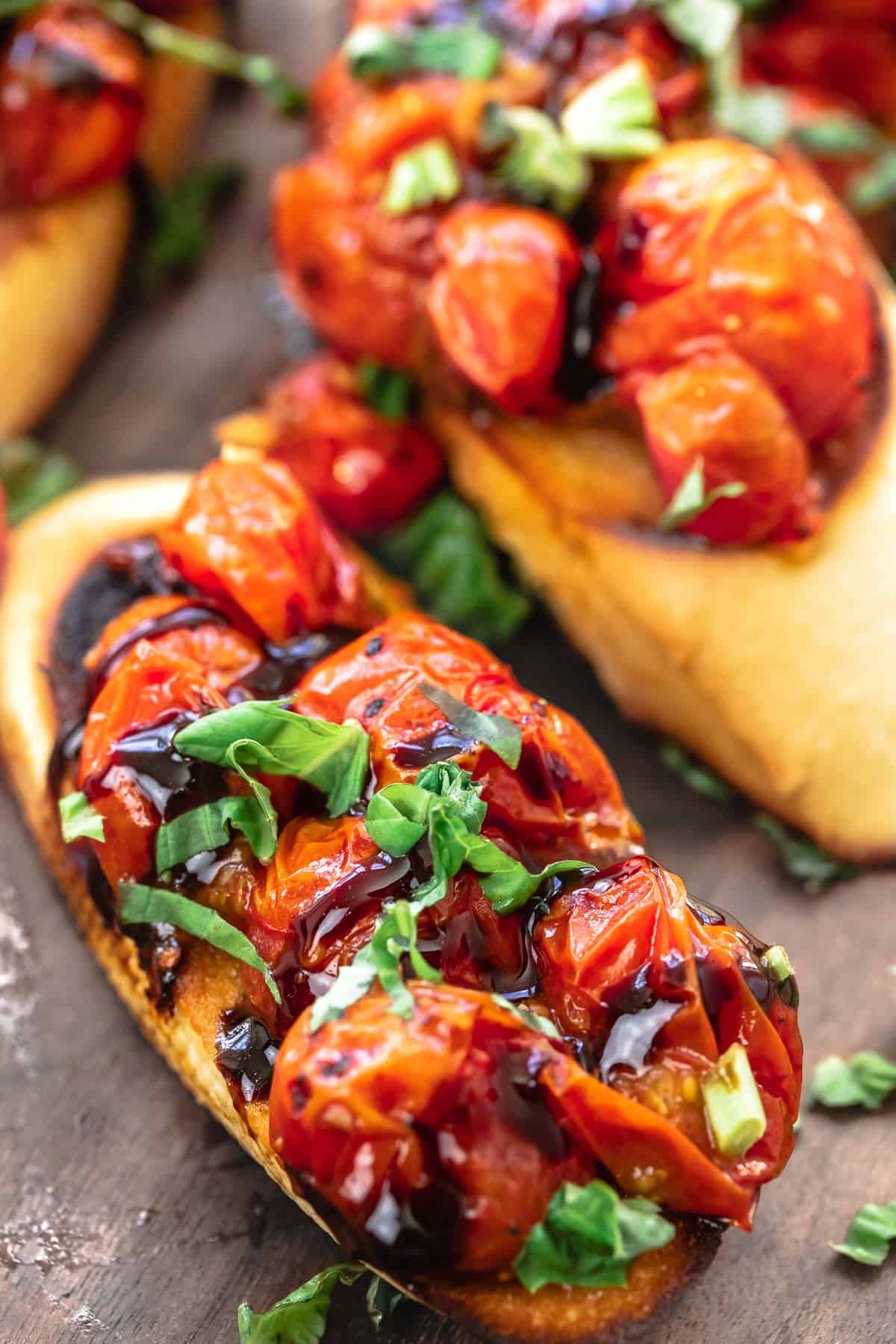 sliced toasted baguette with blistered tomatoes, balsamic glaze, and fresh basil (bruschetta)