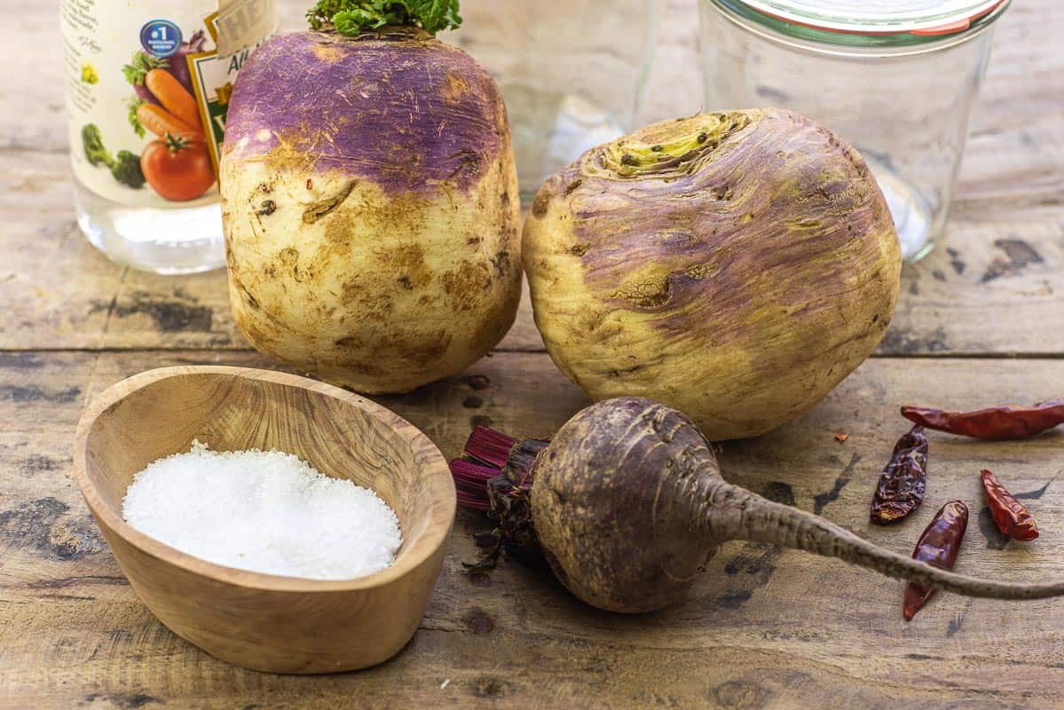 ingredients for pickled turnips including turnips, beets, salt, white vinegar, and dried chile peppers