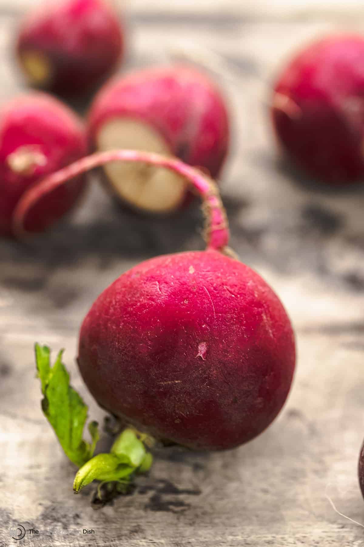 whole radish on a wood surface