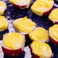 Radish halves with butter spread on top and salt