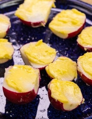 Radish halves with butter spread on top and salt