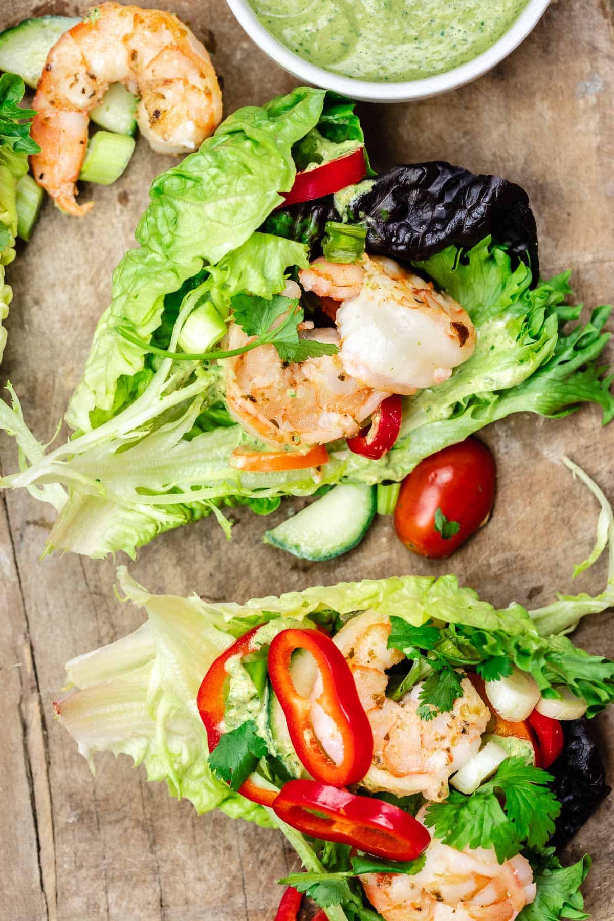 loaded lettuce wraps with shrimp, vegetables, herbs, and vegan green goddess dressing on the side