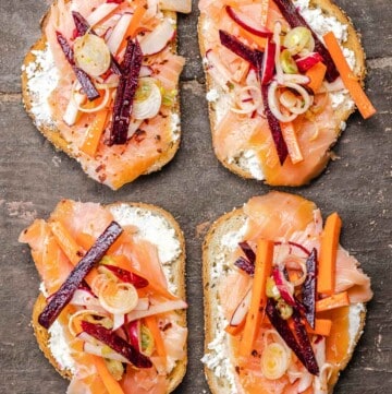 smoked salmon sandwiches on a wooden board