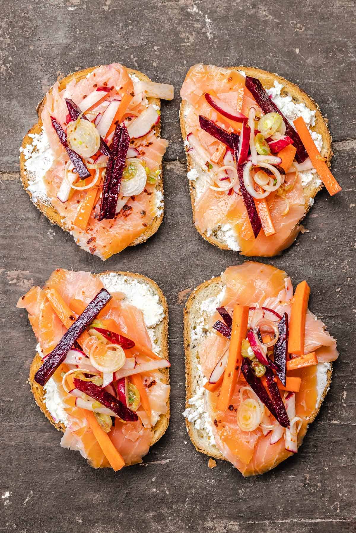 smoked salmon sandwiches on a wooden board