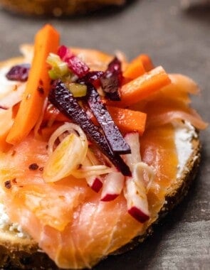 smoked salmon over toast with feta and root vegetables like carrots and beets