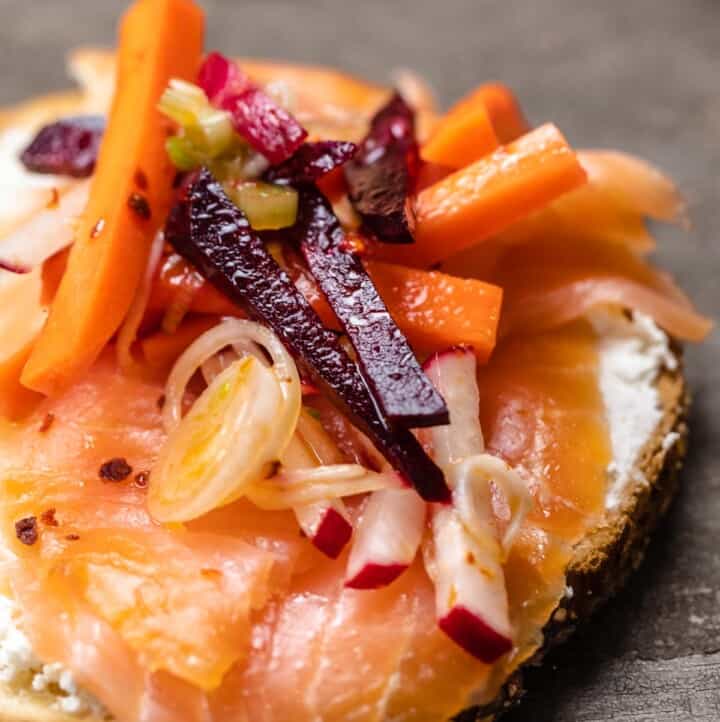 smoked salmon over toast with feta and root vegetables like carrots and beets