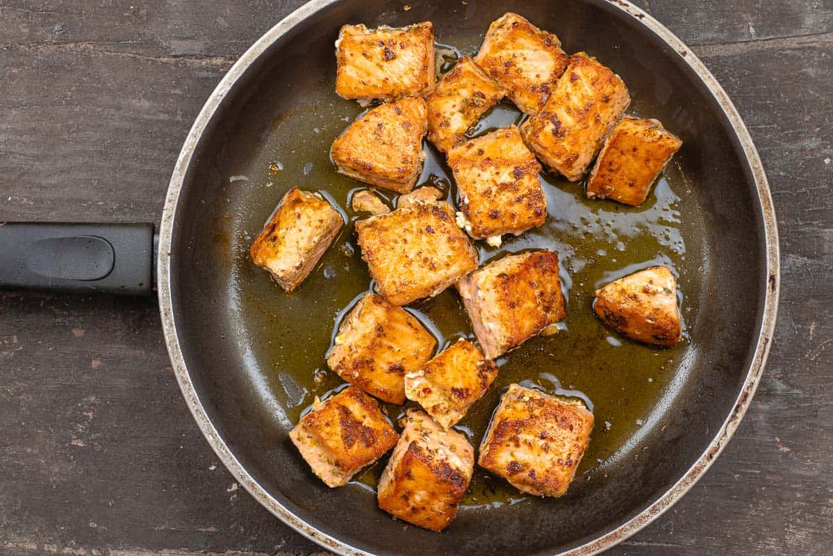 pan-seared salmon with extra virgin olive oil in a skillet