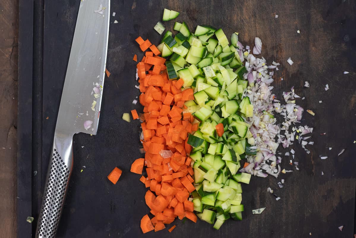 chopped carrots, cucumber, and shallots for grilled corn salad.