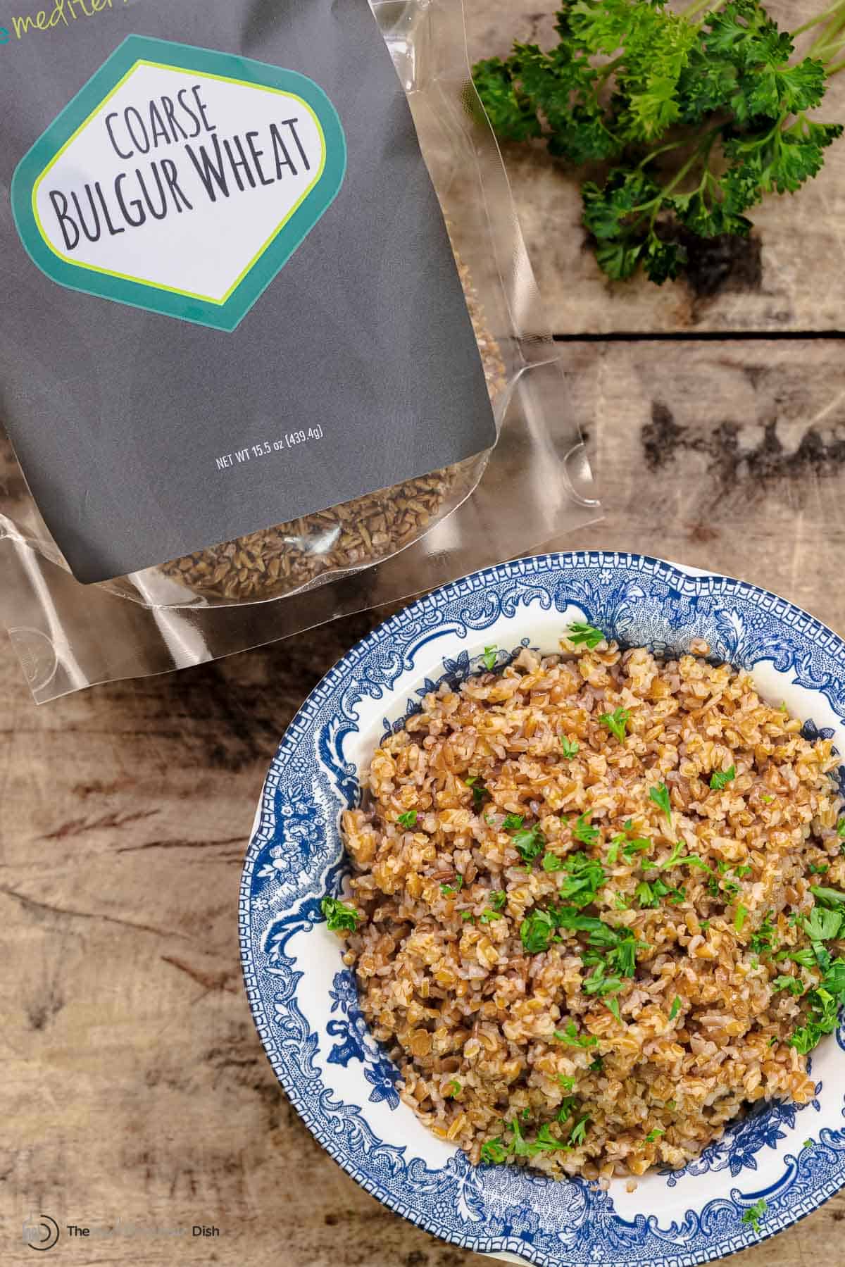 coarse bulgur wheat in a bowl next to The Mediterranean Dish bulgur wheat