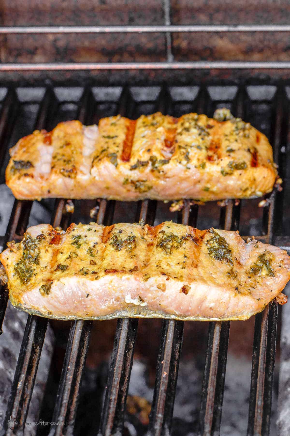 two pieces of salmon on the grill. Flesh side with grill marks up. 