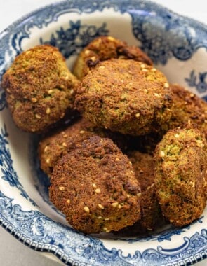 several air fryer falafel patties in a blue and white bowl.
