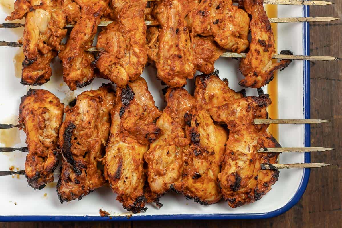 grilled chicken doner kebabs on a platter.